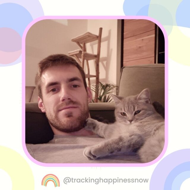 The man is hugging the cat.